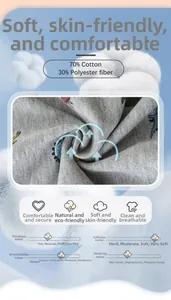 Detail of grey knitted fabric with dinosaur print showing 70% cotton and 30% polyester blend