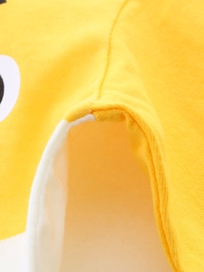 Close-up of high-quality double-stitch seam on yellow long-sleeved cotton t-shirt for boys