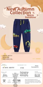 Detail of boys navy cotton sweatpants with embroidered trucks and yellow drawstring
