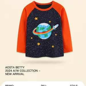 Detail of kids long sleeve shirt with space planet and rocket prints on soft cotton