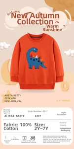 Close-up of orange kids sweatshirt with dinosaur patch and 100% cotton fabric detail