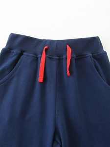 Kids' navy blue autumn sweatpants with elastic ribbed waistband and red drawstring detail