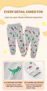 Detail of gray kids joggers with festive Christmas prints and ribbed elastic cuffs