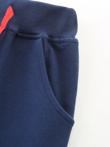 Kids navy blue joggers with red drawstring and ribbed elastic waist details