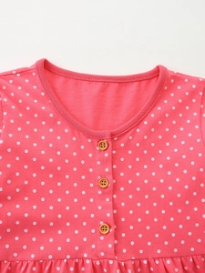 Pink polka dot long sleeve cotton knit girl's dress with round neck and wooden buttons