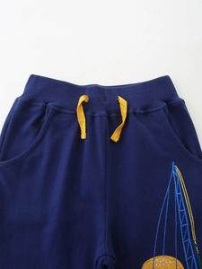 Boys navy cotton jogger pants with elastic waist, yellow drawstring and patch detail