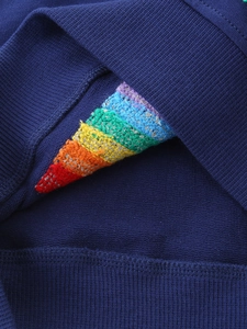 Navy girls sweatshirt with colorful rainbow woven detail and soft terry knit texture