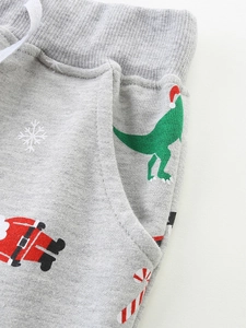 Kids grey Christmas jogger pants featuring festive dinosaur and Santa Claus prints