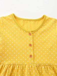 Abito bambina giallo a maniche lunghe con pois bianchi e dettagli bottoni arancioni