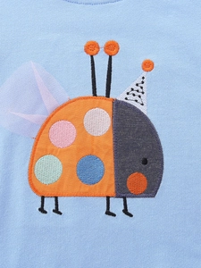 Girl's blue knit sweatshirt featuring a 3D ladybug applique and embroidery detail
