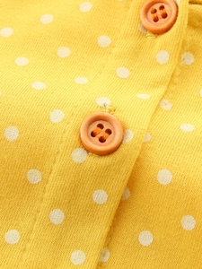 Abito in maglia gialla da bambina con pois bianchi e bottoni arancioni