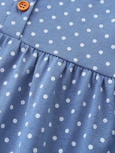 Blue polka dot girl's dress with animal embroidery detail and vintage wooden button