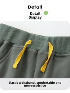 Detailed shot of elastic waistband with yellow drawstring on boys' cotton shorts