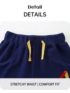 Detail of blue knit shorts featuring an elastic ribbed waistband with yellow drawstrings
