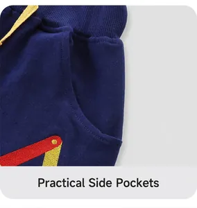 Close-up of boys' navy knit shorts with yellow drawstring and embroidery detail