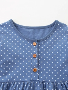 Blue polka dot girl's dress with animal embroidery and brown decorative buttons