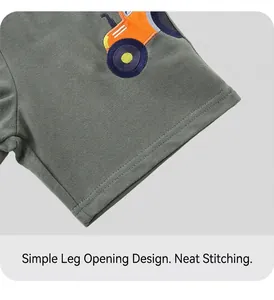 Close-up of tractor embroidery and flat stitching on dark grey cotton boy shorts