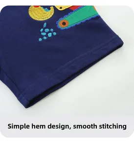 Detail of navy knit shorts featuring colorful excavator embroidery and neat hem stitching