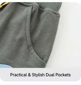 Detailed close-up of side pockets and ribbed waistband on dark gray boys sports shorts