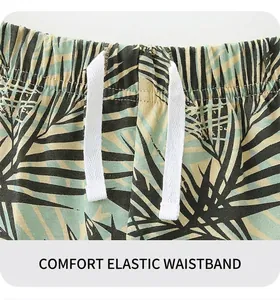 Detail view of elastic waistband with white drawstrings on palm leaf print boy's shorts