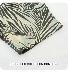 Detail of tropical leaf print shorts with reinforced stitching on breathable cotton fabric