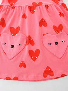 Pink girl's summer dress featuring cute heart prints and large heart-shaped pockets