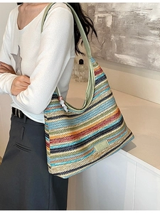 Rainbow woven tote bag with colorful stripes and green leather shoulder strap for women