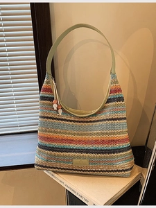 Rainbow striped woven tote bag with green leather handles and large capacity design