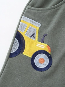 Boys' army green knit sports shorts featuring a detailed cartoon tractor embroidery