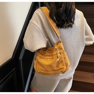 Detailed view of ginger canvas tote bag with multi-zipper pockets and wide shoulder strap