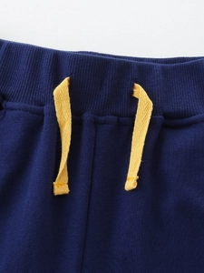 Boys navy knit sports shorts with elastic ribbed waist and yellow drawstring details