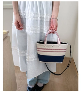 Close-up of the red striped canvas beach bag with woven handles and leather strap