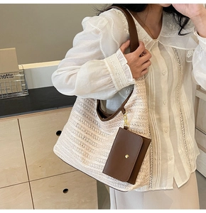 Detail of hand-woven beige hobo bag with dark brown leather strap and small pouch