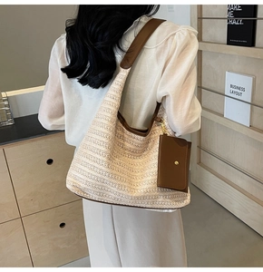 Detail of beige straw shoulder bag with dark brown leather straps and mini pouch attachment