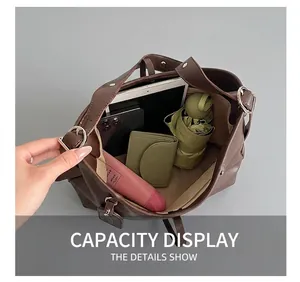 Interior view showing large capacity of dark brown tote bag with daily essentials