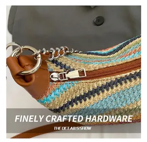 Detailed close-up of rainbow woven tote bag featuring silver zipper and brown leather trim