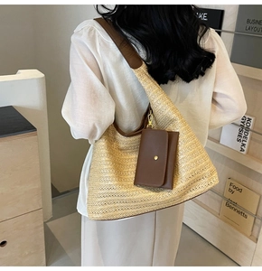 Detail of woven straw shoulder bag with brown leather trim and matching coin purse