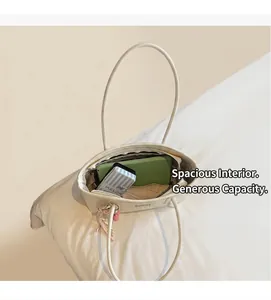Spacious inner compartment of cream faux leather tote bag with tablet and daily items