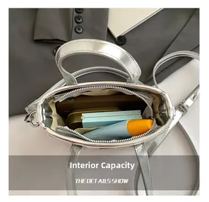 Top view of silver metallic bucket bag showing interior space with phone and makeup items