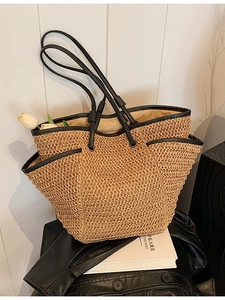 Minimalist straw tote bag with black leather straps for beach holidays and daily use