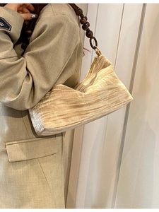 Beige pleated shoulder bag with wooden beaded strap for women in minimalist style