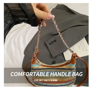 Close-up of a colorful striped woven hobo bag with chain handle and brown leather strap