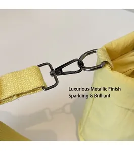 Detail of yellow canvas bucket bag with durable dark grey metal spring snap hooks