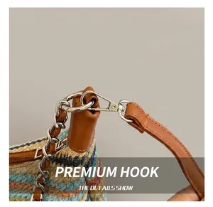 Detail showing high-quality silver metal hooks and leather straps on rainbow woven tote bag