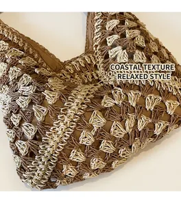 Detail of khaki and cream crochet pattern on large woven straw tote bag for beach vacations