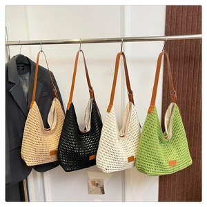 Detail of woven straw tote bags in four colors with brown leather shoulder straps