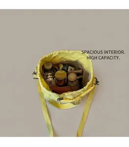Internal view of yellow drawstring bucket bag showing high capacity for daily items