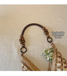 Detail of woven straw tote bag with retro wooden beads and a brown braided shoulder strap