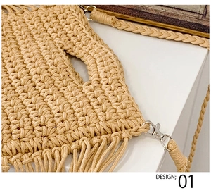 Close-up of beige crochet tote bag showing detailed woven texture and tassel accents