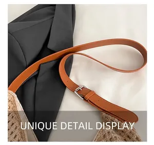 Close-up of beige hollow-out woven tote with adjustable brown leather shoulder strap